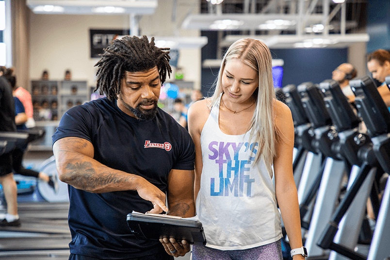 Personal Trainer and client discussing a workout program