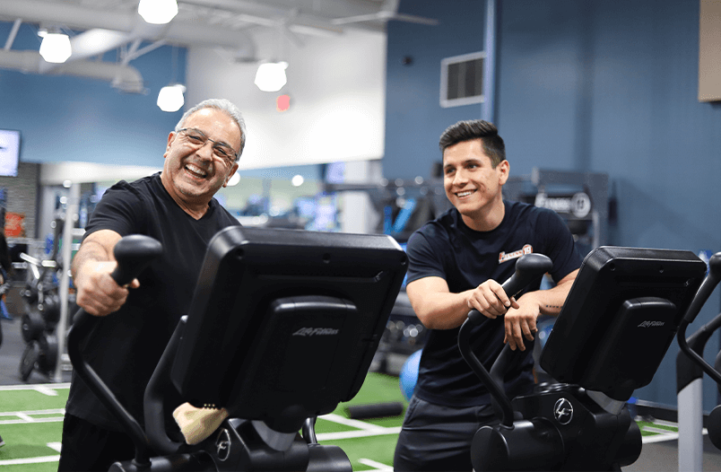 Trainer and client on cardio machines
