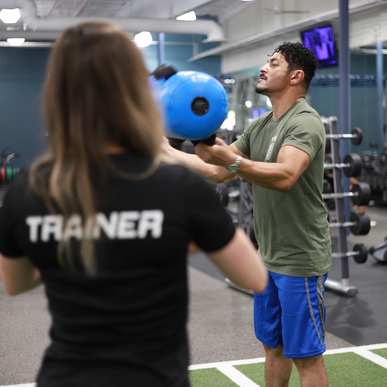 physical trainer working with client